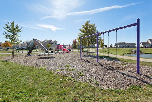 view of playground featuring a water view and a lawn