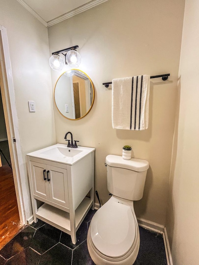 bathroom with tile patterned floors, vanity, toilet, and ornamental molding