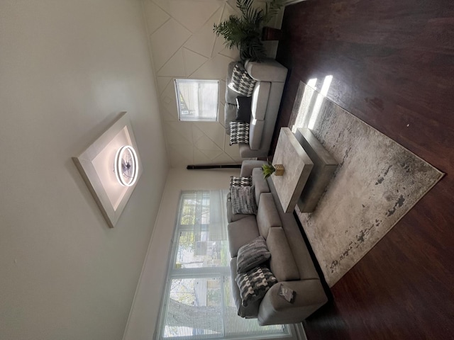 unfurnished living room with dark wood-type flooring