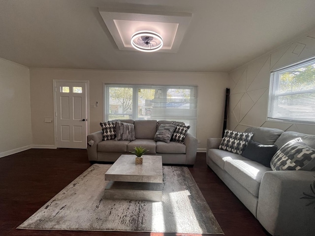 living room featuring plenty of natural light and dark wood-type flooring