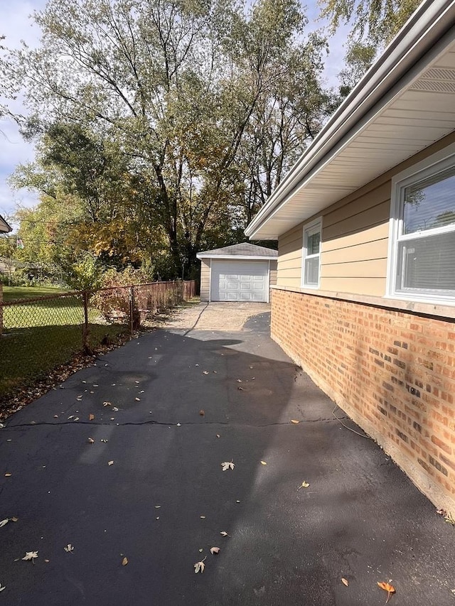 view of side of property featuring a garage and an outdoor structure