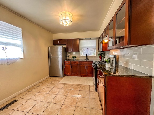 kitchen featuring backsplash, a healthy amount of sunlight, and stainless steel appliances