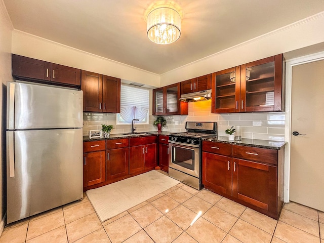 kitchen featuring backsplash, sink, light tile patterned floors, and stainless steel appliances