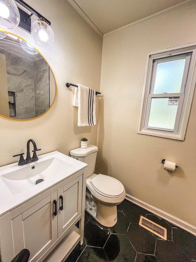 bathroom featuring tile patterned flooring, vanity, toilet, and ornamental molding