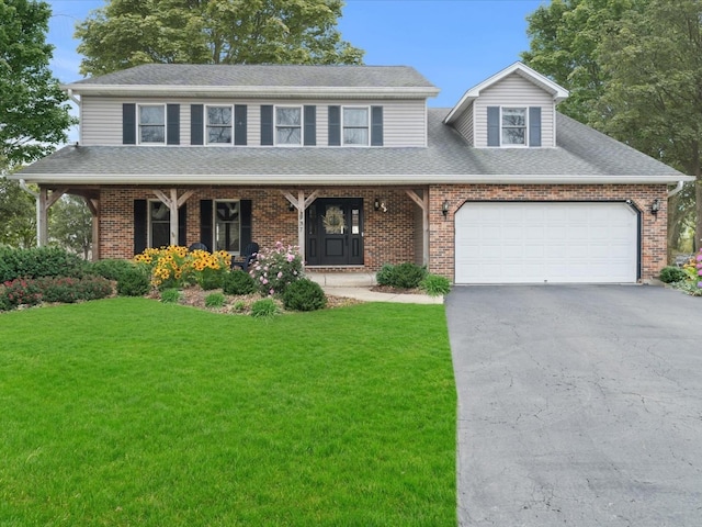 view of front facade featuring a garage, a front lawn, and a porch