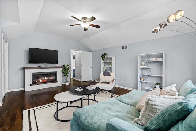 living room featuring dark wood-type flooring, vaulted ceiling, and ceiling fan