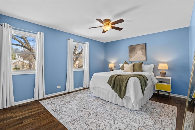 bedroom with dark hardwood / wood-style floors and ceiling fan