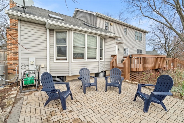 back of property with a patio area and a deck