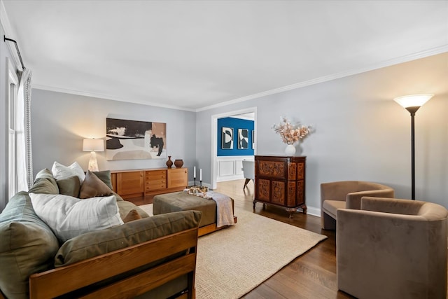 living room with dark wood-type flooring and ornamental molding