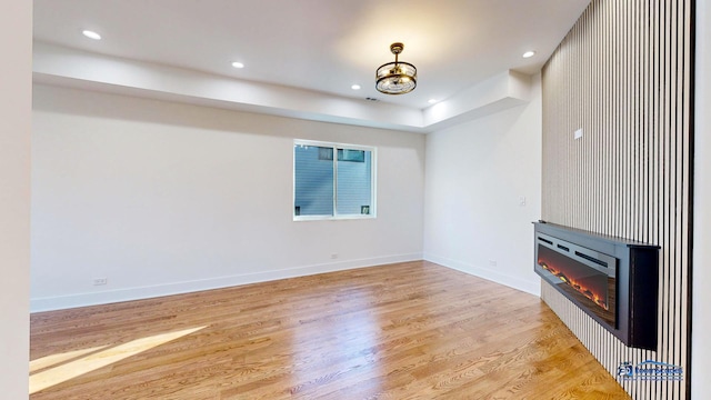 unfurnished living room with a fireplace and light hardwood / wood-style flooring