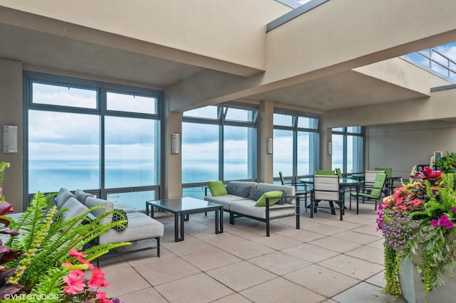 sunroom / solarium with a water view