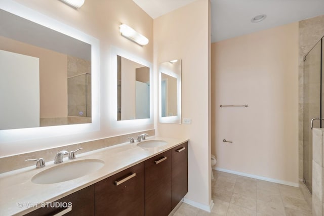 bathroom with tile patterned flooring, vanity, toilet, and an enclosed shower