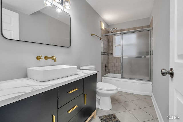 full bathroom featuring tile patterned flooring, vanity, enclosed tub / shower combo, and toilet