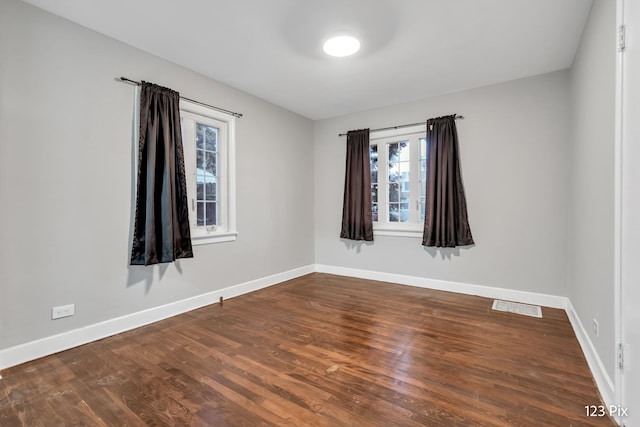 unfurnished room with hardwood / wood-style floors