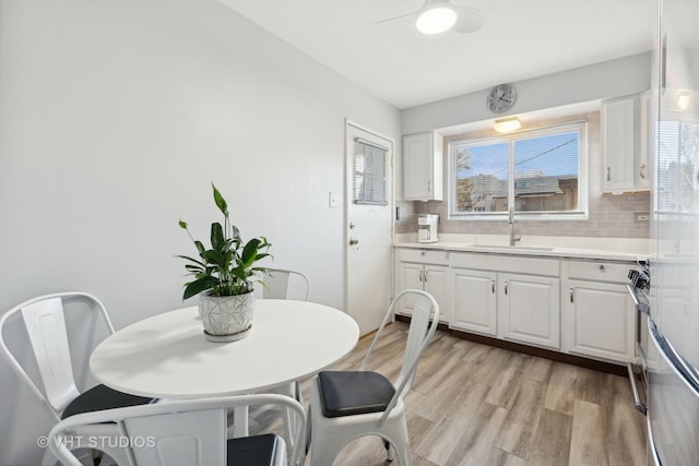 dining room featuring sink and light wood-type flooring