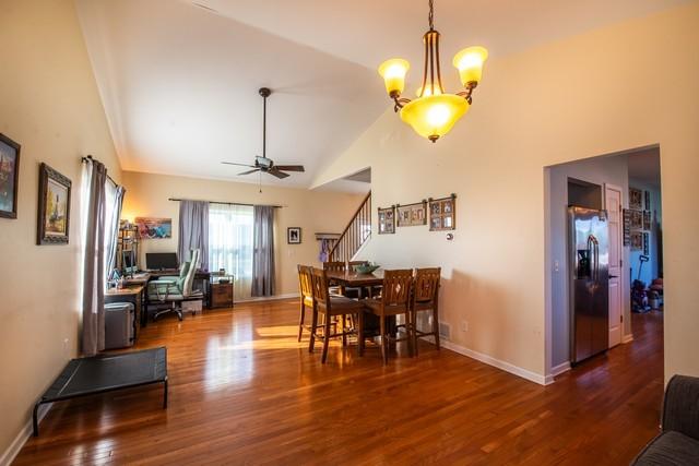 kitchen with decorative light fixtures, sink, light wood-type flooring, and stainless steel appliances