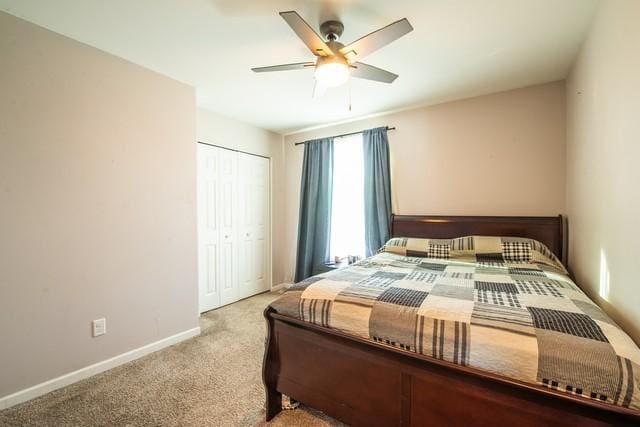 bedroom featuring light carpet, a closet, and ceiling fan