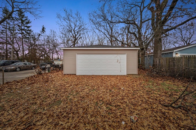 view of garage at dusk