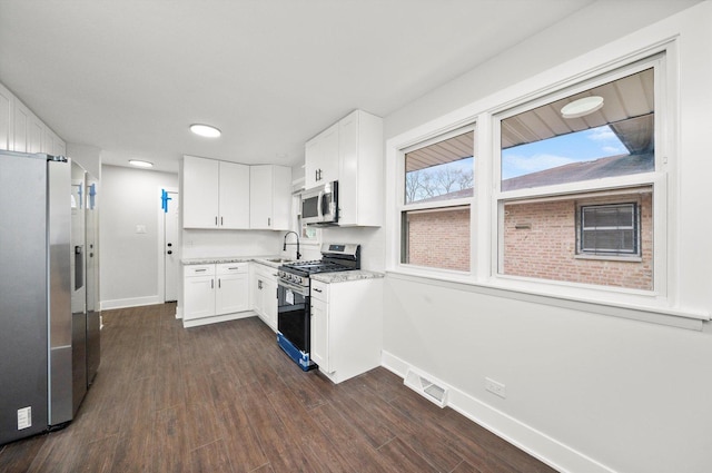 kitchen with white cabinets, sink, dark hardwood / wood-style flooring, and stainless steel appliances