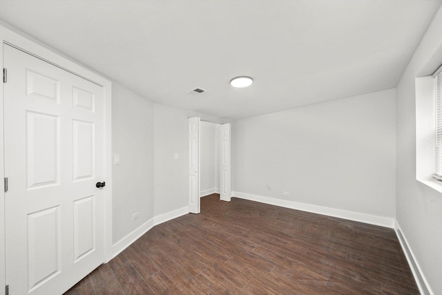 empty room with dark hardwood / wood-style floors