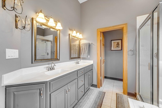 bathroom with tile patterned flooring, vanity, and walk in shower