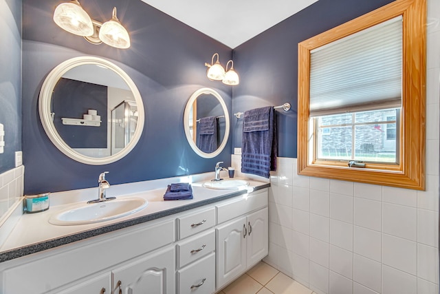 bathroom featuring tile patterned flooring, vanity, and tile walls