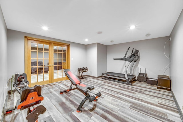 exercise area with french doors and light hardwood / wood-style flooring