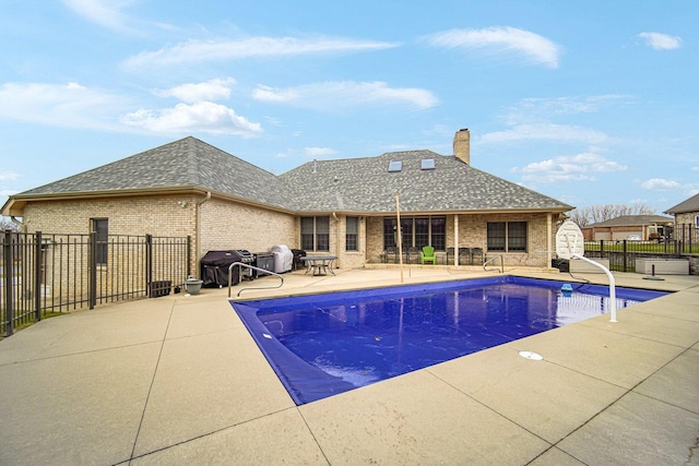 view of pool featuring a patio area and grilling area