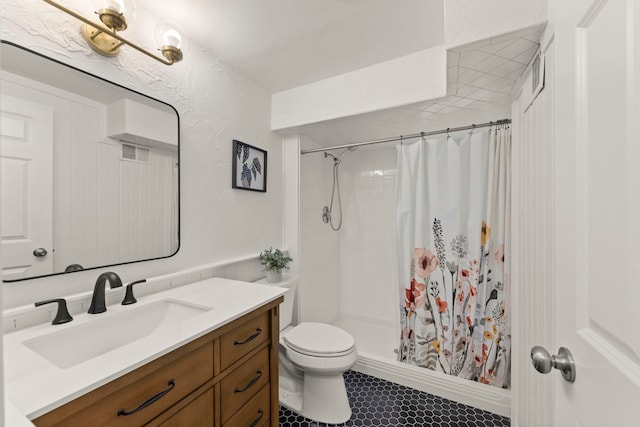 bathroom featuring a textured wall, toilet, visible vents, vanity, and a stall shower