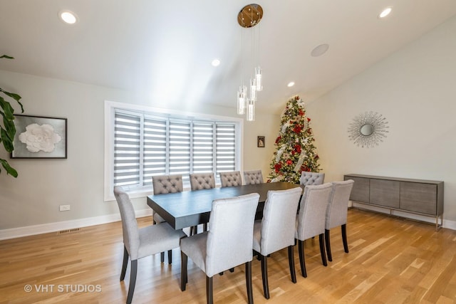 dining space featuring light hardwood / wood-style flooring and lofted ceiling