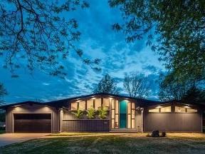 view of front of house featuring a garage and a front lawn