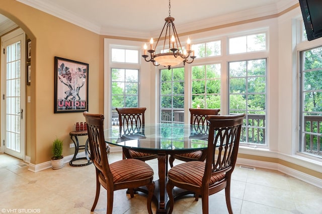 dining area with crown molding, light tile patterned floors, and a chandelier