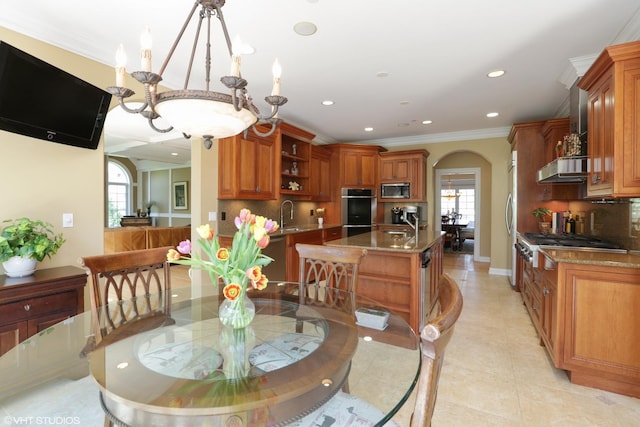 dining space with sink, light tile patterned floors, plenty of natural light, and ornamental molding