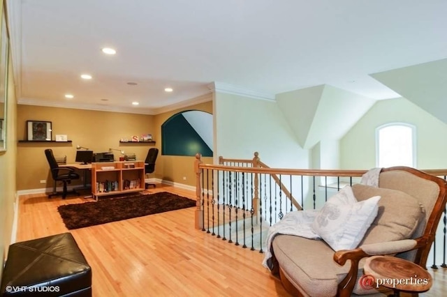 living area featuring hardwood / wood-style flooring and ornamental molding