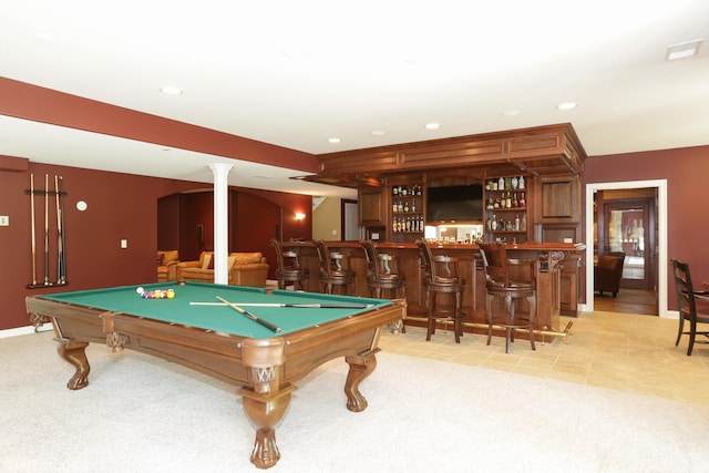 rec room with pool table, decorative columns, light colored carpet, and indoor bar