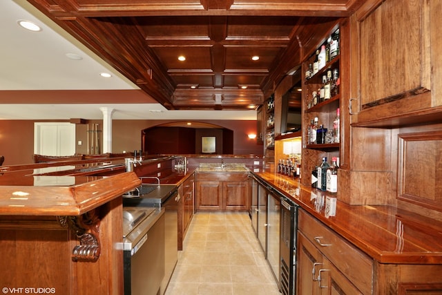 bar with light tile patterned floors, dark stone countertops, coffered ceiling, beverage cooler, and beamed ceiling