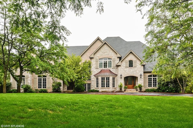 french country home featuring a front lawn