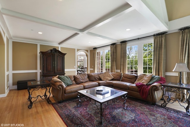 living room featuring beam ceiling, coffered ceiling, and light wood-type flooring