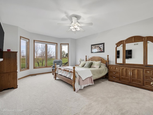 bedroom featuring light carpet and ceiling fan