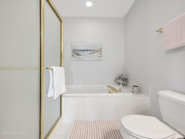 bathroom featuring tile patterned flooring, shower with separate bathtub, and toilet