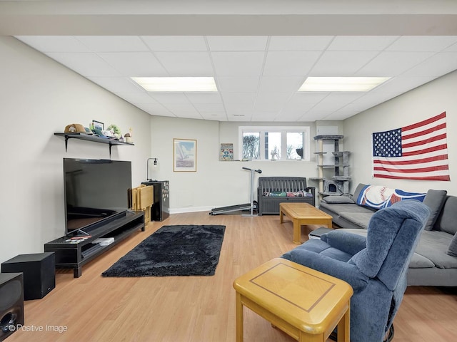 living room featuring a paneled ceiling and wood-type flooring