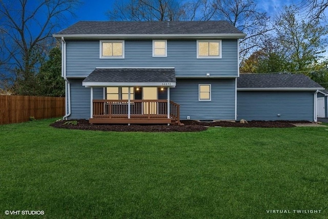 back of house with a yard and a wooden deck