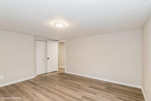 unfurnished room with hardwood / wood-style flooring