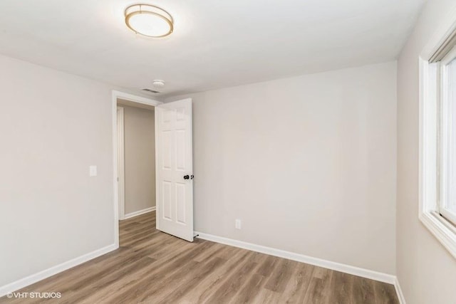 unfurnished room featuring hardwood / wood-style floors