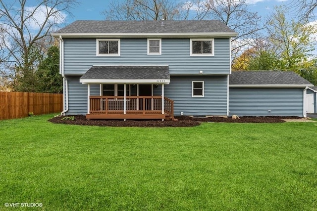 rear view of property with a lawn and a wooden deck