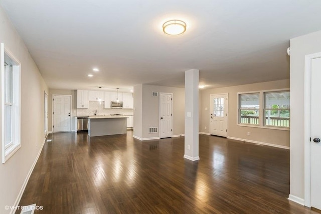 unfurnished living room with dark hardwood / wood-style floors