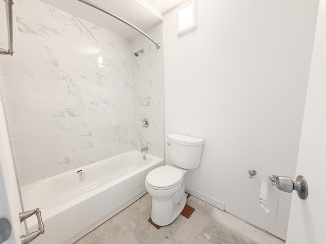 bathroom featuring tiled shower / bath and toilet