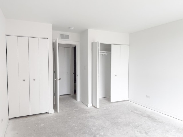 unfurnished bedroom with multiple closets