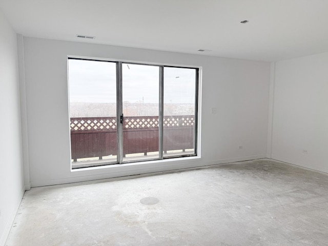 spare room with concrete floors