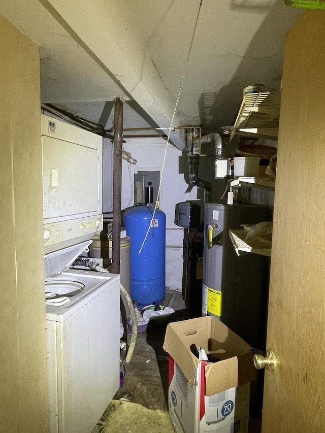 utility room featuring stacked washer / dryer, water heater, and electric panel